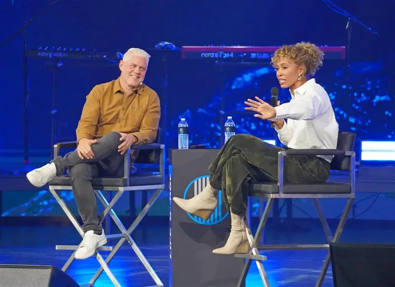Chris Graebe and Sage Steele speak on stage during Life Surge Las Vegas, a faith-based event empowering believers to live with purpose and boldness.