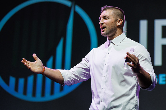 Tim Tebow speaking on the Life Surge stage