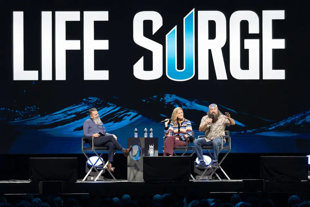 Shawn Marcell, Korie Robertson, and Willie Robertson speak on stage at Life Surge San Diego 2025 at Pechanga Arena, inspiring attendees toward faith-driven leadership and Kingdom impact.
