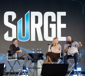 Life Surge Tucson event panel featuring Shawn Marcell with Willie and Korie Robertson on stage discussing faith and Kingdom impact