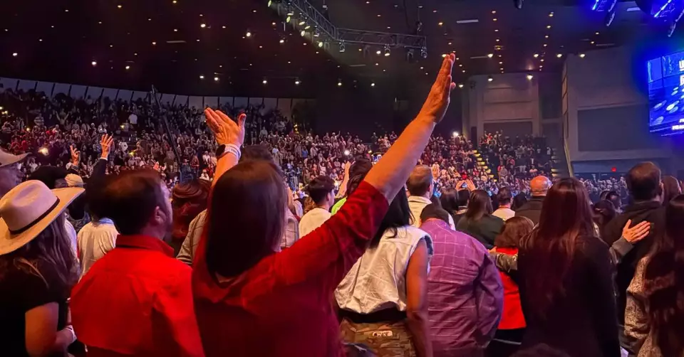 Worshiping crowd at a Life Surge Christian event, reflecting spiritual awakening and community faith experience.